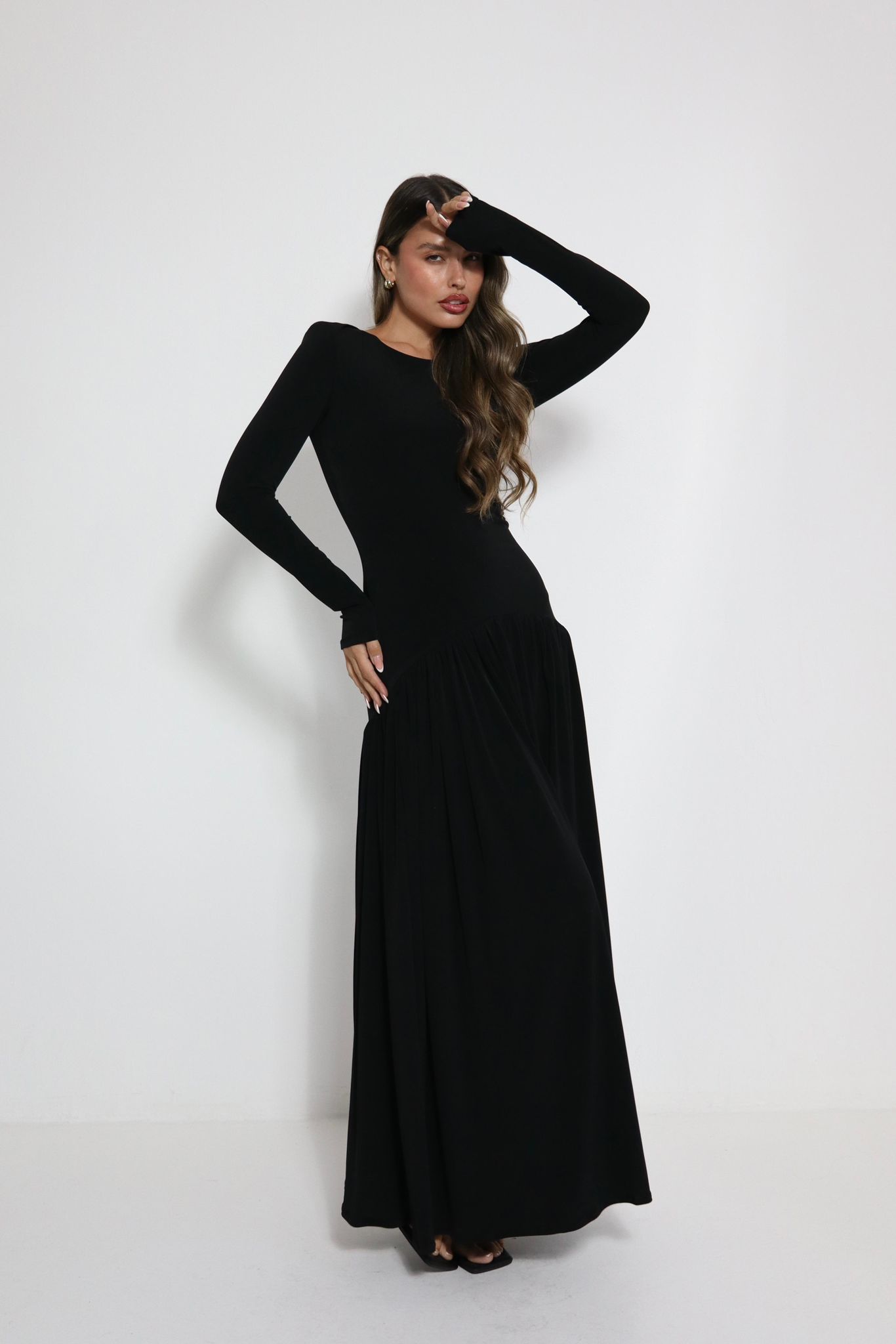 Woman wearing elegant black maxi dress from the Orly Tahal 2026 Collection